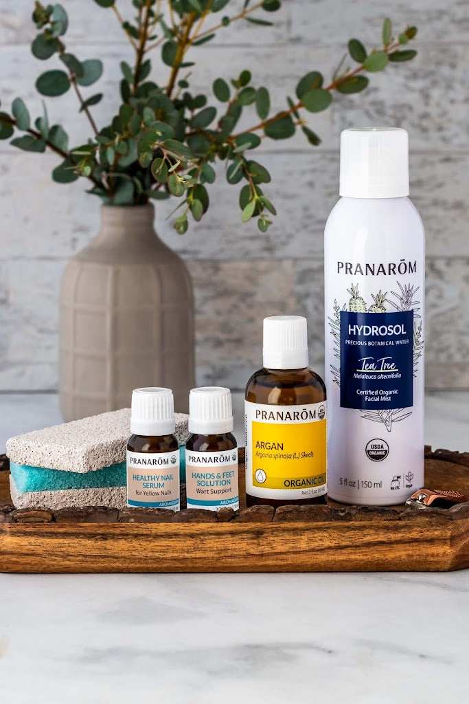Pranarom Certified Organic Healthy Nail Serum, Hands & Feet Solution, Argan Virgin Plant Oil, Tea Tree Hydrosol Facial Mist bottles with green plant and sponges.