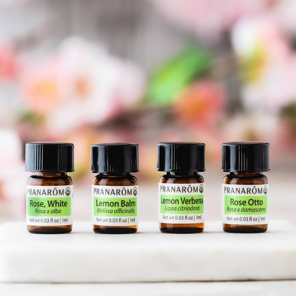 Pranarom Certified Organic Rose, White, Lemon Balm, Lemon Verbena, and Rose Otto Essential Oil bottles.