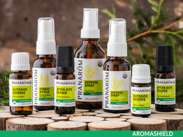 Pranarom Certified Organic Aromashield Outdoor Defense, Forest & Field, After-Bite Eraser, Defense Spray, Defense Spray Kids, Outdoor Defense Kids, and After-Bite Eraser Kids bottles and circular wood blocks.