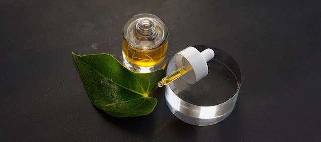 Pranarom Certified Organic Glow Treatment Oil bottle and cap with leaf.