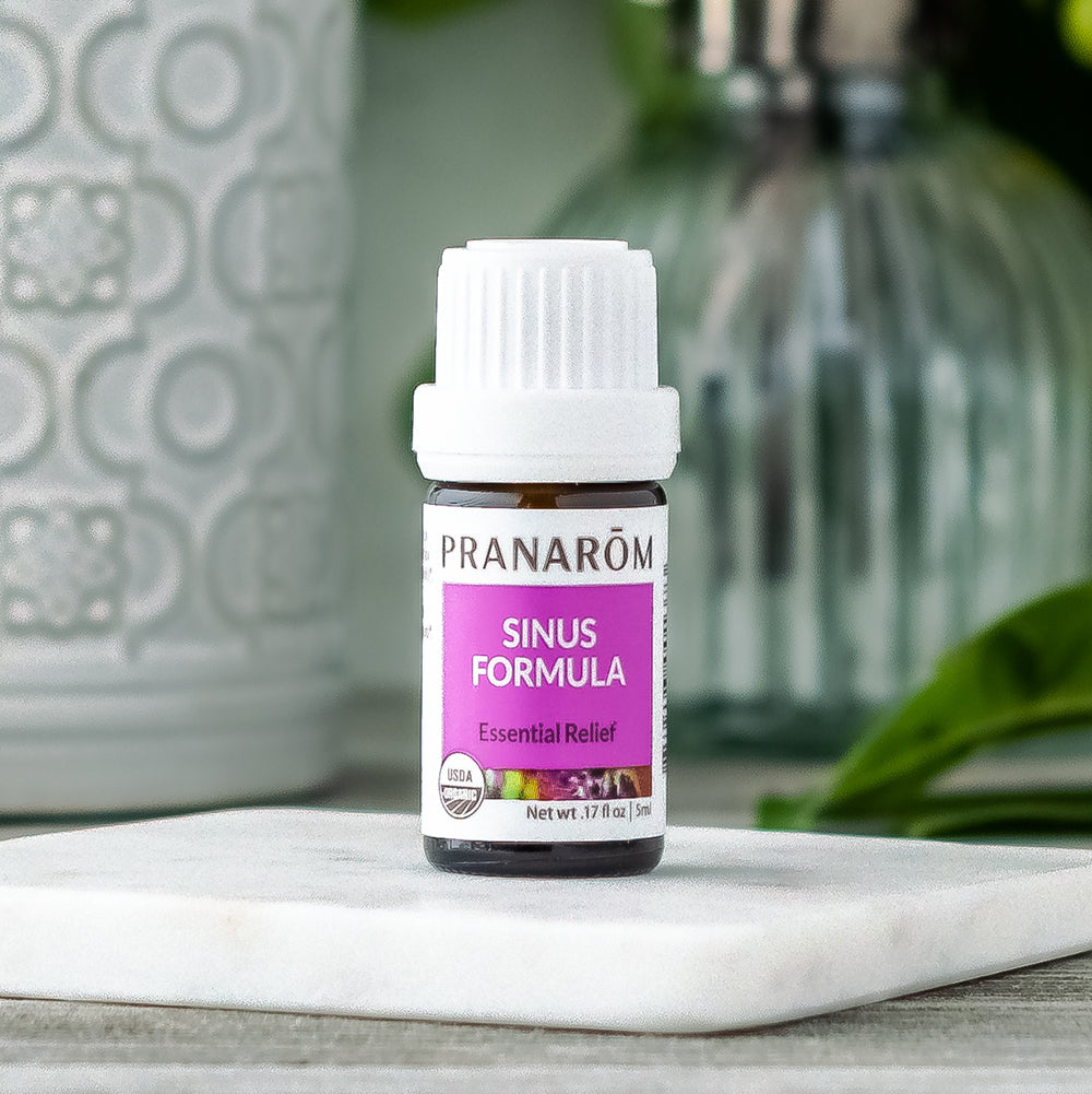 Pranarom Certified Organic Sinus Formula Wellness Formula bottle and stone.