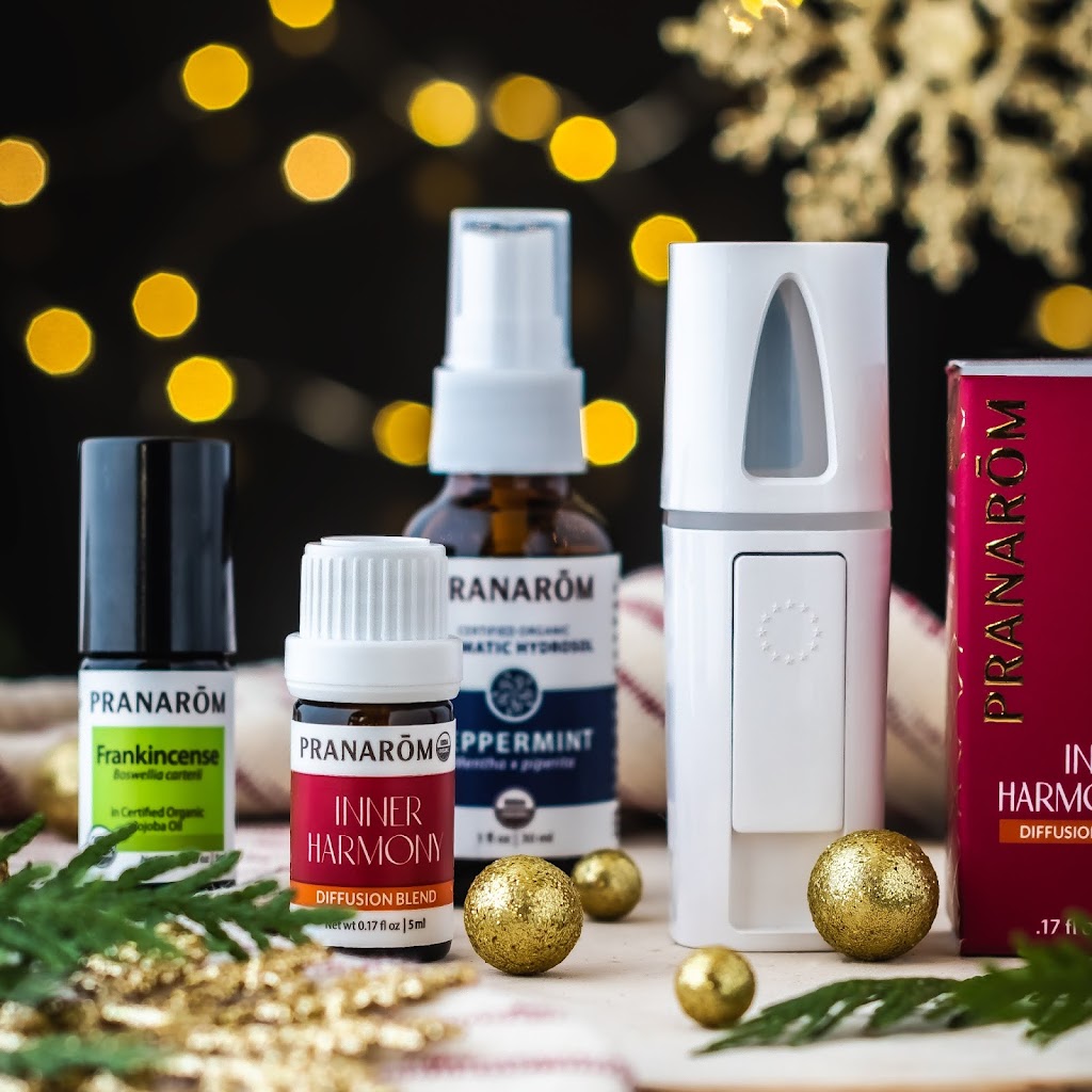 Pranarom Certified Organic Frankincense Essential Oil, Inner Harmony Diffusion Blend, Peppermint Aromatic Hydrosol, Hand Diffuser bottles and Inner Harmony Diffusion Blend bottle with festive background.