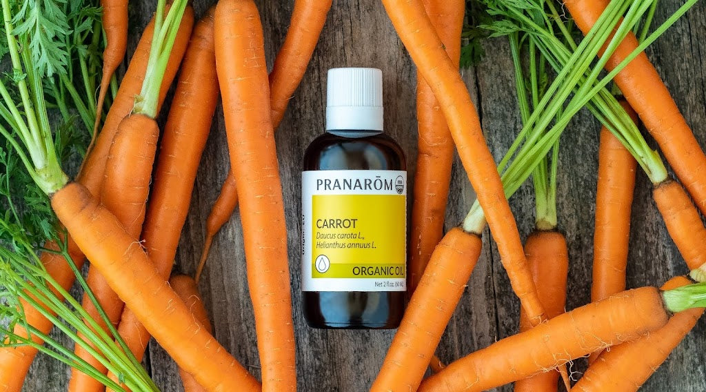 Pranarom Certified Organic Carrot Virgin Plant Oil bottle with carrots.